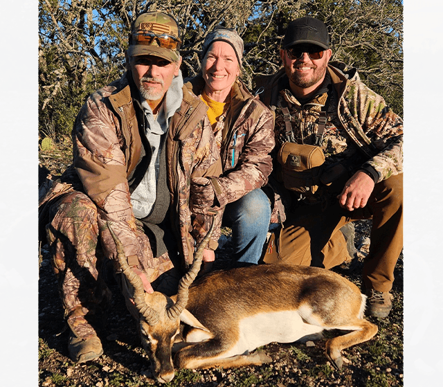 Three hunters with a blackbuck antelope