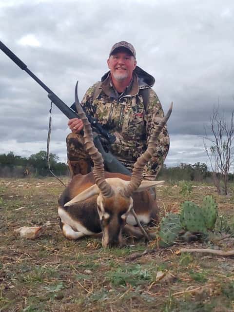 Hunter with a rifle and blackbuck antelope