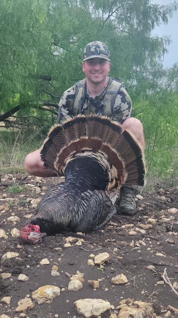 Hunter displaying a turkey's fanned tail